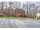 Traditional two-story brick home with black shutters and a manicured front lawn at 1975 Skidmore Cir, Lawrenceville, GA 30044