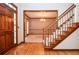 Foyer with hardwood floors and staircase with entryway into dining room at 1975 Skidmore Cir, Lawrenceville, GA 30044