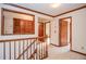 Hallway on the second story of the home with several doors, windows, and wood trim at 1975 Skidmore Cir, Lawrenceville, GA 30044