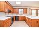 Eat-in kitchen with wood cabinets, white countertops and tile flooring at 1975 Skidmore Cir, Lawrenceville, GA 30044