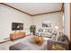 Staged living room with neutral tones, cozy seating, and natural light at 1975 Skidmore Cir, Lawrenceville, GA 30044