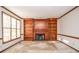 Cozy living room with a brick fireplace, wood trim, and built-in bookshelves at 1975 Skidmore Cir, Lawrenceville, GA 30044