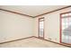 Empty living room showcasing decorative moulding, carpet flooring, and natural light at 1975 Skidmore Cir, Lawrenceville, GA 30044