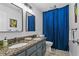 Bathroom featuring double sink vanity with granite countertops and blue shower curtain at 2262 Ridgedale Ne Rd, Atlanta, GA 30317