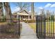 Inviting home with wrought iron fence, mature trees, and a charming front porch at 2262 Ridgedale Ne Rd, Atlanta, GA 30317