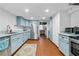 Spacious kitchen features stainless steel appliances, blue cabinets, and red terracotta tile flooring at 2262 Ridgedale Ne Rd, Atlanta, GA 30317