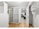 Spacious walk-in closet with custom shelving units, and wood flooring. The room is bright and inviting at 2262 Ridgedale Ne Rd, Atlanta, GA 30317