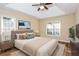 This staged bedroom features a calming beach view, a comfy bed, and natural light at 241 The Esplanade Se Way, Loganville, GA 30052