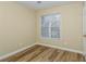 Bedroom with a window and wood floors, offering a simple and clean design at 241 The Esplanade Se Way, Loganville, GA 30052