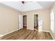 Well-lit bedroom featuring vaulted ceilings, hardwood floors, and ensuite access at 241 The Esplanade Se Way, Loganville, GA 30052