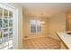 Sunlit dining area with tile flooring, large windows, and a view of the backyard at 241 The Esplanade Se Way, Loganville, GA 30052