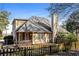 Back exterior of a two-story home featuring a chimney, yard space, and fence at 241 The Esplanade Se Way, Loganville, GA 30052