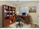 Staged office featuring hardwood floors, a desk, and a bookshelf for a professional workspace at 241 The Esplanade Se Way, Loganville, GA 30052