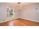 Dining room with hardwood floors, window with plantation shutters and modern light fixture at 970 Winding Creek Trl, Atlanta, GA 30328