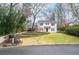 Charming two-story home with a landscaped front yard, complemented by black shutters and a red front door at 970 Winding Creek Trl, Atlanta, GA 30328