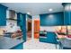 Bright kitchen featuring stainless steel appliances, gas range, and eye-catching teal cabinetry at 970 Winding Creek Trl, Atlanta, GA 30328