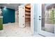 Bright kitchen showcasing ample pantry space, geometric tile flooring, and access to a screened porch at 970 Winding Creek Trl, Atlanta, GA 30328