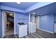 Spacious laundry room with modern washer and dryer, along with storage options and practical layout at 970 Winding Creek Trl, Atlanta, GA 30328