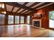 Staged living room featuring a fireplace and wood paneling throughout at 970 Winding Creek Trl, Atlanta, GA 30328