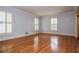 Bright, open living room with hardwood floors and white shuttered windows at 970 Winding Creek Trl, Atlanta, GA 30328