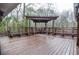 Wooden deck featuring pergola, bench seating, and a wooded backdrop at 970 Winding Creek Trl, Atlanta, GA 30328