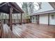 Spacious wooden deck features pergola, bench seating, and a view of the house at 970 Winding Creek Trl, Atlanta, GA 30328