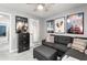 Bedroom featuring a gray sofa, movie posters, storage cabinet and a window with natural light at 1925 Barnett West Ct, Buford, GA 30518