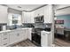 Charming kitchen with white cabinets, subway tile backsplash, and stainless steel appliances at 1925 Barnett West Ct, Buford, GA 30518