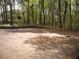 Community basketball court surrounded by mature trees offers outdoor recreational space at 412 E Pharr Rd, Decatur, GA 30030
