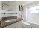 Bathroom featuring granite countertops, vanity and shower-tub combo with glass shelf at 412 E Pharr Rd, Decatur, GA 30030