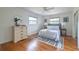 Bright bedroom with hardwood floors, ceiling fan, natural light, and neutral decor at 412 E Pharr Rd, Decatur, GA 30030