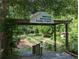 Entrance to Oakhurst Community Garden Project, featuring raised garden beds and lush greenery at 412 E Pharr Rd, Decatur, GA 30030