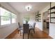 Bright dining room with hardwood floors, modern decor, and a view into the kitchen at 412 E Pharr Rd, Decatur, GA 30030