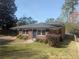 Charming brick home featuring a new roof, manicured lawn, and a quaint entrance with a vibrant blue door at 412 E Pharr Rd, Decatur, GA 30030