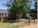 Brick building exterior with an American flag, landscaping, and a little library at 412 E Pharr Rd, Decatur, GA 30030