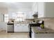 Bright kitchen featuring white cabinets, stainless steel appliances, granite countertops, and tile backsplash at 412 E Pharr Rd, Decatur, GA 30030