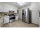 Updated kitchen with stainless steel appliances, sleek white cabinets, and granite countertops at 412 E Pharr Rd, Decatur, GA 30030