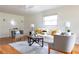 Elegant living room with hardwood floors, neutral furniture, stylish decor, and a ceiling fan at 412 E Pharr Rd, Decatur, GA 30030