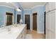 Bright bathroom featuring double sinks, a separate shower, and ample cabinet space at 6220 Crofton Dr, Alpharetta, GA 30005