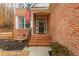 Close up of the brick front porch with front door and decorative wreath at 6220 Crofton Dr, Alpharetta, GA 30005