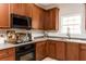 Bright kitchen featuring wooden cabinets, stainless steel appliances, and light countertops at 6220 Crofton Dr, Alpharetta, GA 30005