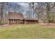 View of the back of the home with a screened in porch and a spacious yard at 120 Arrowood Ln, Alpharetta, GA 30009