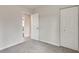 Neutral bedroom featuring a double door closet and door to another room at 120 Arrowood Ln, Alpharetta, GA 30009