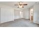 Spacious carpeted bedroom with ceiling fan, large closets, and access to bath at 120 Arrowood Ln, Alpharetta, GA 30009
