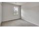 This bedroom offers neutral walls, soft carpet, and a bright window at 120 Arrowood Ln, Alpharetta, GA 30009