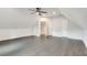 Large bonus room with wood-look floors and multiple access doors at 120 Arrowood Ln, Alpharetta, GA 30009
