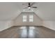 A large bonus room featuring wood-look floors, dormer ceilings, and bright windows at 120 Arrowood Ln, Alpharetta, GA 30009