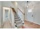 Home foyer featuring tiled floors, a staircase, and a white front door at 120 Arrowood Ln, Alpharetta, GA 30009