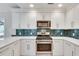 A modern kitchen featuring white cabinets, stainless steel appliances, and quartz countertops at 120 Arrowood Ln, Alpharetta, GA 30009