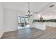 Bright, modern kitchen featuring white cabinets, stainless steel appliances, and an adjacent sunroom with a dining set at 120 Arrowood Ln, Alpharetta, GA 30009